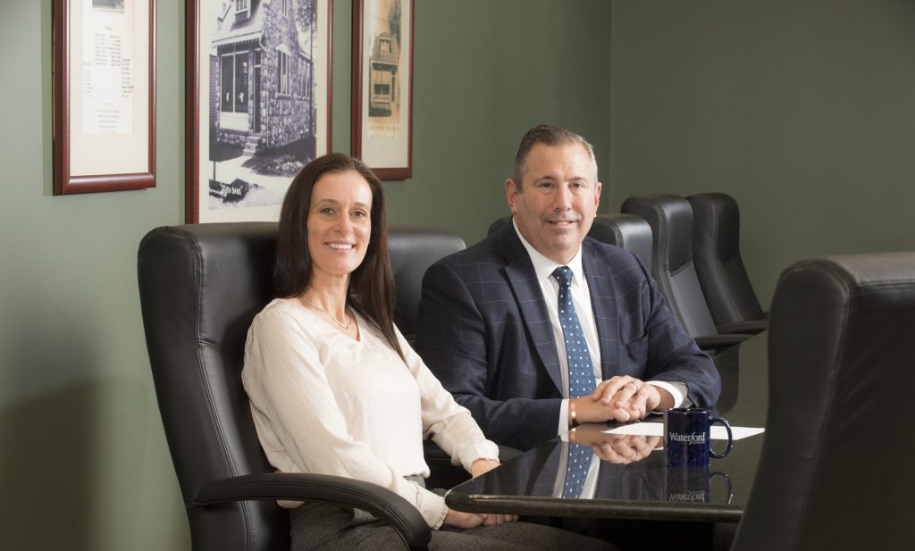 Michigan Lending Team sitting at a table and smiling at camera.