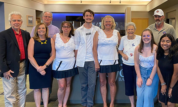 Community outreach - Bankers pose with group of students and their families who just received Kirk Gibson College scholarships.