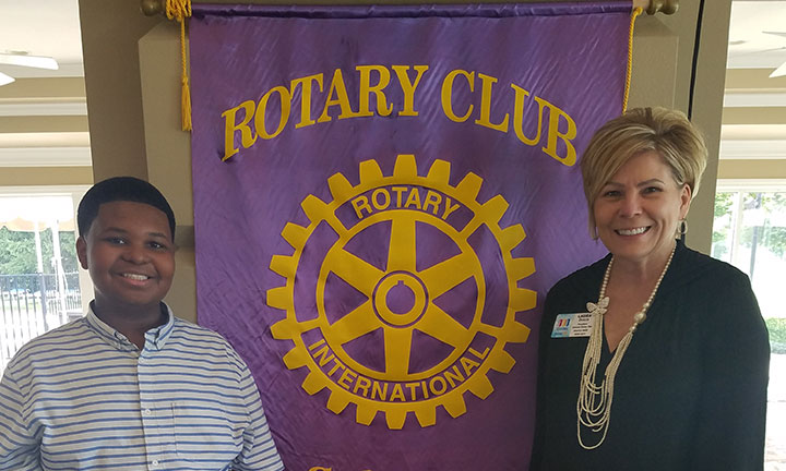 Community outreach - Sylvania Rotary Club Event, Female banker smiling with youth attendee.