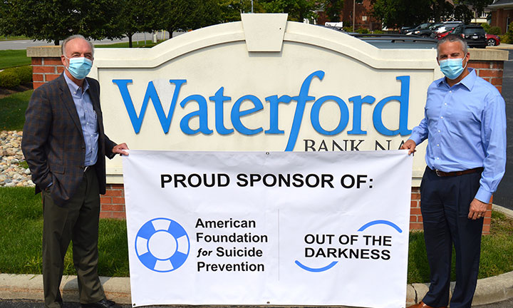 Community outreach - Waterford Bankers hold sign in support of suicide prevention
