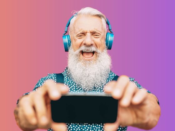 An older gentleman enjoying using his mobile phone.