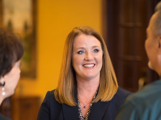 Treasury team member smiling at customers.