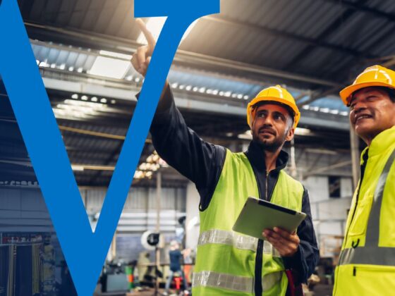 Two business owners look at their warehouse and assess a business expansion.