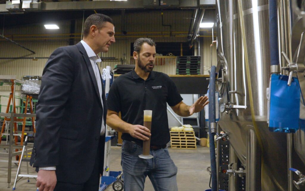 Greg Silloway looking at equipment with customer.