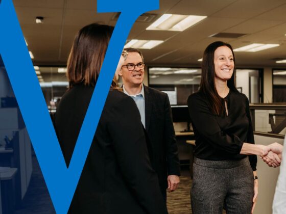 A banker shakes hands with a customer.