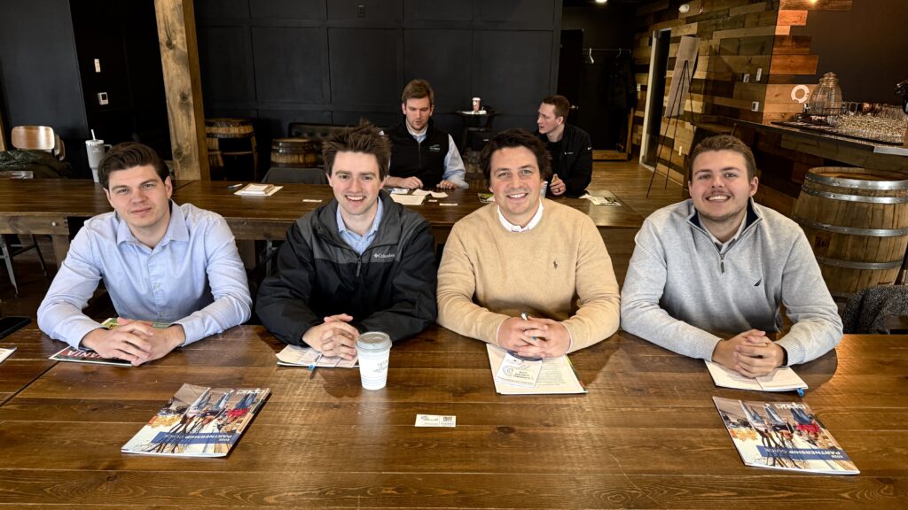 Four Waterford Young Professionals smile for a photo after an event.