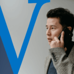 Business man holding a phone to his ear looking concerned.