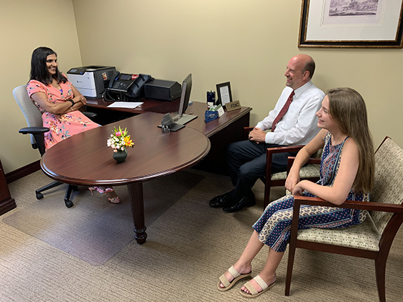 A Waterford Banker discussing minor accounts with a father and his young daughter.