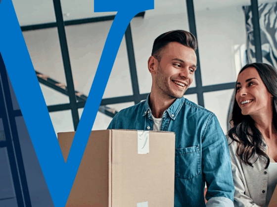 A smiling couple carries moving boxes into their new home, looking at each other happily. A large blue “W” watermark representing Waterford Bank overlays the left side of the image.