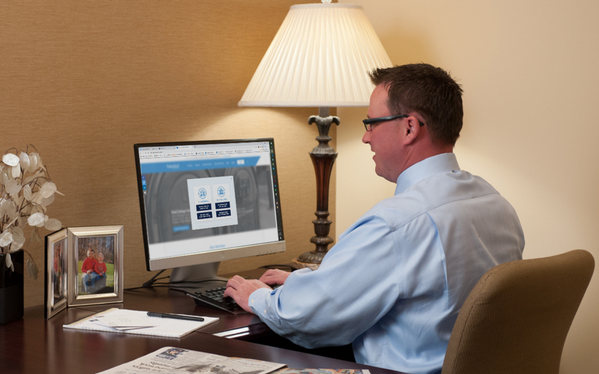 Man reviewing his online banking account on a desktop computer.