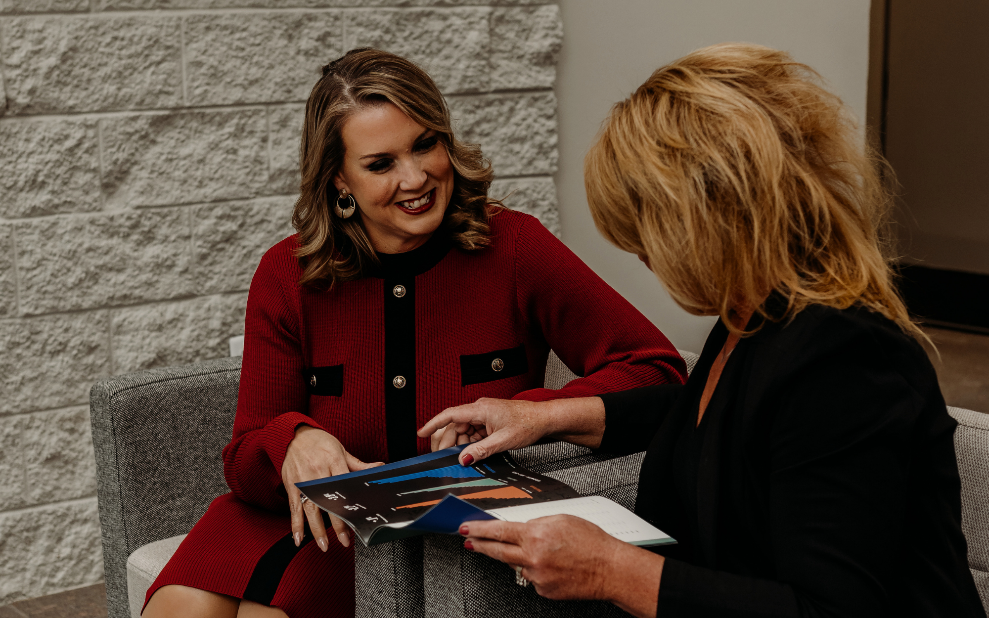 Alison Frye reviews Waterford's Annual Report with a client.